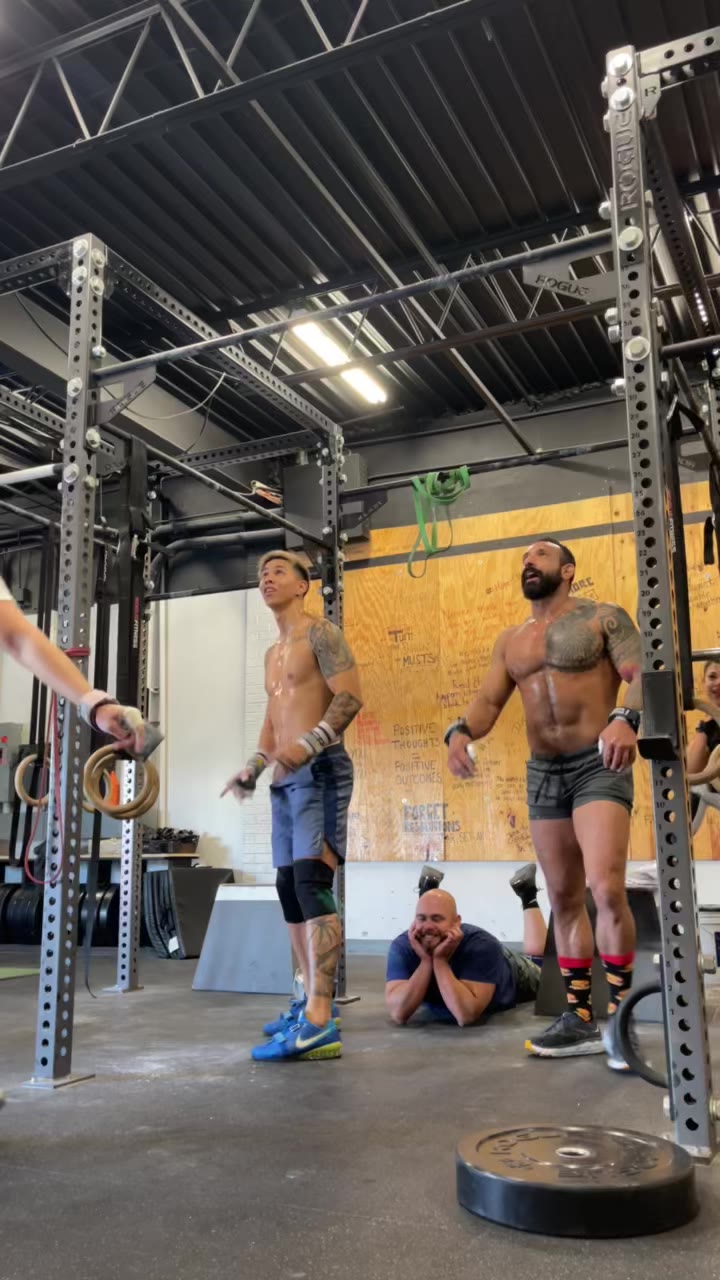 Guy standing at the pull-up rig at Rev40 between sets.